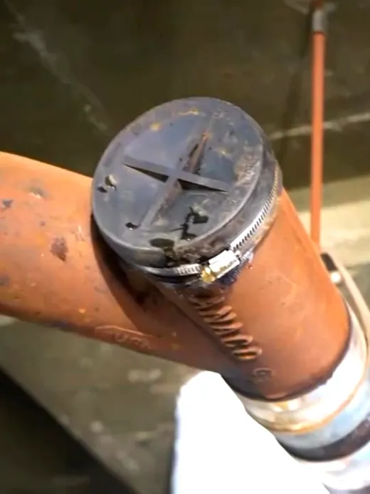 A cast iron waste line joined with a shielded no-hub coupling