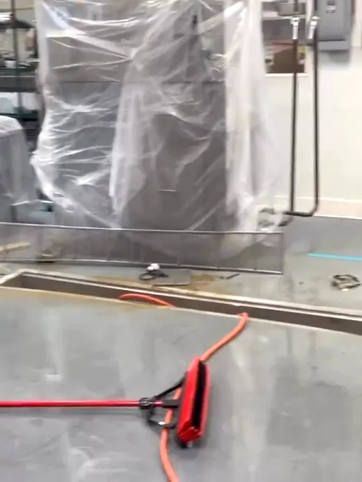 A technician walking the finished floor with the containment still standing behind