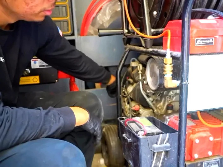 A hydro jetting machine set up on a job with its hose reel and pressure lines run out